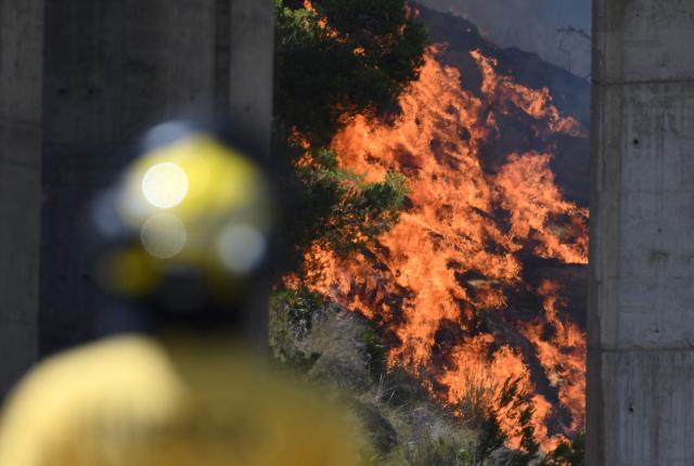 Firefighters of the Infoca (Andalusia Wildfire Service) monitor a fire in the area of a wildfire that killed 11 near Bedar, in Los Gallardos district, in Almeria Province, on July 10, 2026. Eleven people were killed and 19 are missing after a wildfire tore through a Spanish village, with four victims who may have been British who were burned in their car, authorities said. (Photo by JOSE JORDAN / AFP)