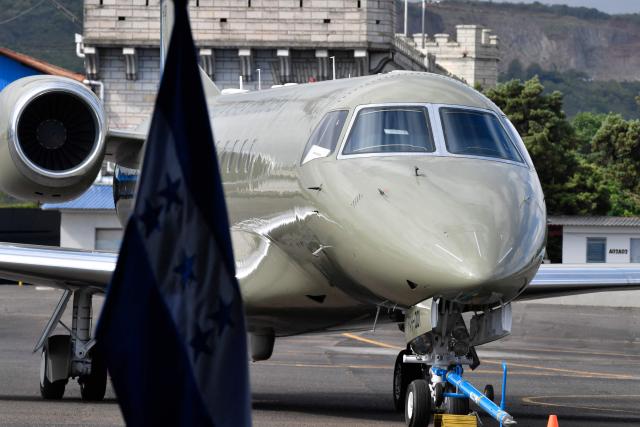 View of the Honduran presidential airplane, which will be auctioned off as part of austerity measures, as it remains parked at the Hernan Acosta Mejia Air Base in Tegucigalpa on July 10, 2026. The Embraer Legacy 600 jet, which purchase and maintenance have been marred by allegations of corruption, was acquired by Honduran President (2014–2022) Juan Orlando Hernandez. (Photo by Orlando SIERRA / AFP)