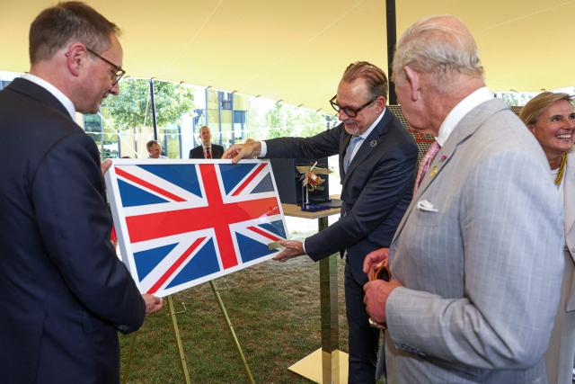 A Union flag that was flown to the International Space Station on June 5, 2023, and returned to Earth on April 30, 2024, is presented to Britain's King Charles III by European Space Agency Director General Dr. Josef Aschbacher, during his Majesty's visit to the Harwell Campus, during a visit to Oxford, west of London on July 10, 2026. (Photo by Toby Shepheard / POOL / AFP)