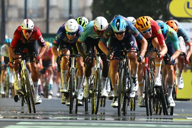 Soudal Quick-Step team's Belgian rider Tim Merlier (C) sprints to the finish line to win the 7th stage of the 113th edition of the Tour de France cycling race, 175 km between Hagetmau and Bordeaux in southwestern France, on July 10, 2026. (Photo by Anne-Christine POUJOULAT / AFP)