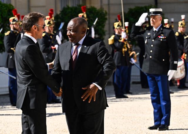 France's President Emmanuel Macron (L) welcomes and shakes hands with his South African counterpart Cyril Ramaphosa at the Elysee Presidential Palace in Paris on July 10, 2026. (Photo by JULIEN DE ROSA / AFP)