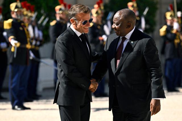 France's President Emmanuel Macron (L) welcomes and shakes hands with his South African counterpart Cyril Ramaphosa at the Elysee Presidential Palace in Paris on July 10, 2026. (Photo by JULIEN DE ROSA / AFP)