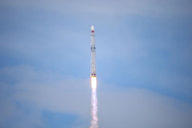 A Long March-10B carrier rocket lifts off from the Hainan Commercial Spacecraft Launch Site in Wenchang in China’s southern Hainan province on July 10, 2026 before the first stage was recovered via a net-based capture system on an offshore recovery platform. The mission, which also launched a satellite into space, marked China's first successful controlled recovery of a carrier rocket's first stage. (Photo by CNS / AFP) / China OUT
