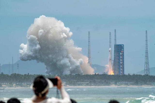 A Long March-10B carrier rocket lifts off from the Hainan Commercial Spacecraft Launch Site in Wenchang in China’s southern Hainan province on July 10, 2026 before the first stage was recovered via a net-based capture system on an offshore recovery platform. The mission, which also launched a satellite into space, marked China's first successful controlled recovery of a carrier rocket's first stage. (Photo by CNS / AFP) / China OUT