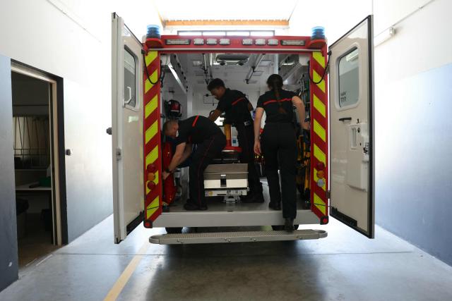Firefighters of Departmental Fire and Rescue Service (SDIS 77) gear up an ambulance at a fire station in Ferrières-en-Brie, the eastern suburbs of Paris, on July 10, 2026. With 36°C in the fire station and some improvised DIY solutions, firefighters are also suffering from the heatwave hitting France. (Photo by Thomas SAMSON / AFP)