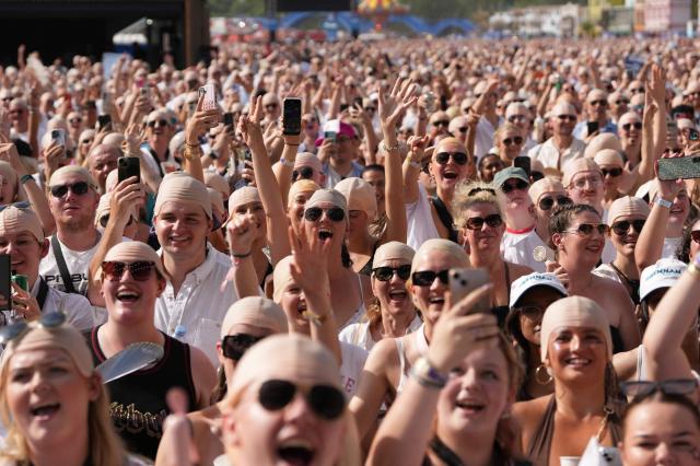 Members of the crowd sporting "bald caps" gather in the sunshine ahead of a concert by US rapper and singer Pitbull in Hyde Park, London, on July 10, 2026. Ahead of the performance an official GUINNESS WORLD RECORDS title attempt for the 'largest gathering of people wearing bald caps' will be held. (Photo by CARLOS JASSO / AFP)