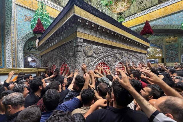 Pilgrims visit the shrine of Imam Reza after the funeral of slain Iranian leader Ali Khamenei and his family members in Mashhad on July 10, 2026. Iran on July 10 laid to rest its former supreme leader Ali Khamenei over four months after his killing in an airstrike, as two days of US and Iranian attacks raised fears of a return to all-out war. (Photo by ATTA KENARE / AFP) / 
