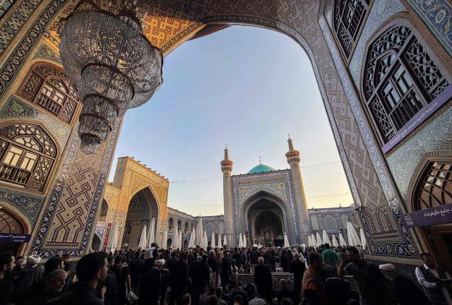 Pilgrims visit the shrine of Imam Reza after the funeral of slain Iranian leader Ali Khamenei and his family members in Mashhad on July 10, 2026. Iran on July 10 laid to rest its former supreme leader Ali Khamenei over four months after his killing in an airstrike, as two days of US and Iranian attacks raised fears of a return to all-out war. (Photo by ATTA KENARE / AFP) / 