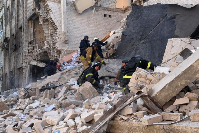 Ukrainian rescuers clear debris at the site of a Russian airstrike in Zaporizhzhia on July 10, 2026, amid the Russian invasion of Ukraine. (Photo by Darya NAZAROVA / AFP)