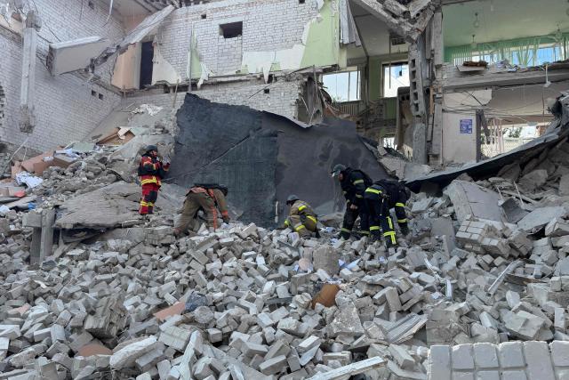 Ukrainian rescuers clear debris at the site of a Russian airstrike in Zaporizhzhia on July 10, 2026, amid the Russian invasion of Ukraine. (Photo by Darya NAZAROVA / AFP)