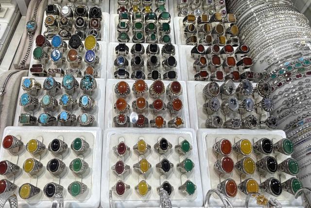 Rings are on display at the Grand Reza Bazaar near the shrine of Imam Reza following the funeral of slain Iranian leader Ali Khamenei and his family members in Mashhad on July 10, 2026. Iran on July 10 laid to rest its former supreme leader Ali Khamenei over four months after his killing in an airstrike, as two days of US and Iranian attacks raised fears of a return to all-out war. (Photo by ATTA KENARE / AFP) / 