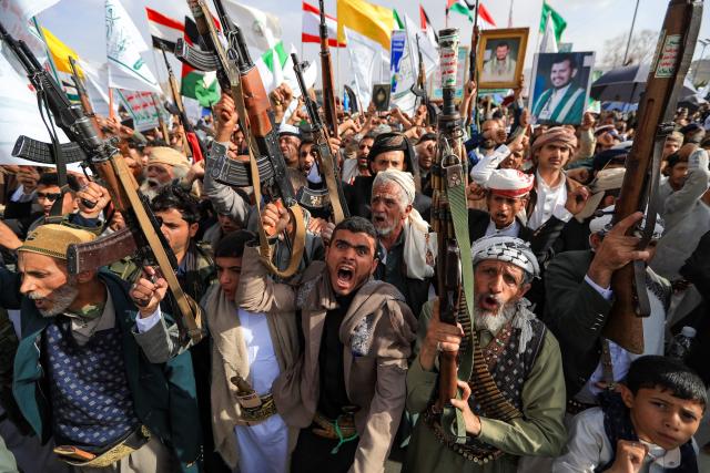 Armed Yemeni supporters of the Iran-backed Houthi movement brandish their weapons during a protest against US strikes on Iran in Sanaa on July 10, 2026. Iran's top negotiator Mohammad Bagher Ghalibaf on July 10 said the conflict with the United States would not end with Tehran's surrender, after hostilities between the decades-old foes resumed this week with tit-for-tat attacks. (Photo by Mohammed HUWAIS / AFP)
