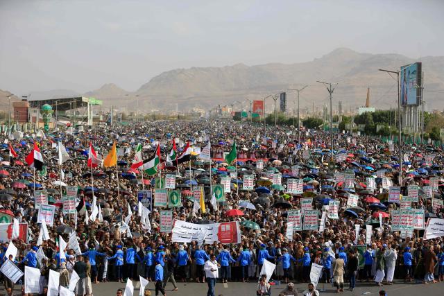 Armed Yemeni supporters of the Iran-backed Houthi movement brandish their weapons during a protest against US strikes on Iran in Sanaa on July 10, 2026. Iran's top negotiator Mohammad Bagher Ghalibaf on July 10 said the conflict with the United States would not end with Tehran's surrender, after hostilities between the decades-old foes resumed this week with tit-for-tat attacks. (Photo by Mohammed HUWAIS / AFP)