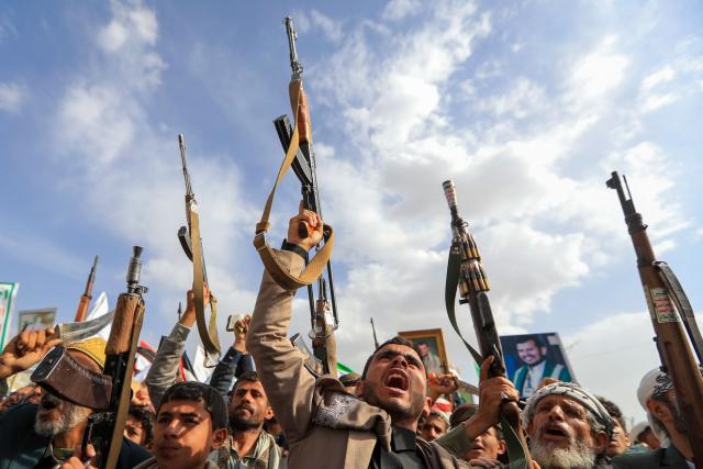 Armed Yemeni supporters of the Iran-backed Houthi movement brandish their weapons during a protest against US strikes on Iran in Sanaa on July 10, 2026. Iran's top negotiator Mohammad Bagher Ghalibaf on July 10 said the conflict with the United States would not end with Tehran's surrender, after hostilities between the decades-old foes resumed this week with tit-for-tat attacks. (Photo by Mohammed HUWAIS / AFP)