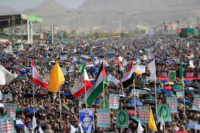 Armed Yemeni supporters of the Iran-backed Houthi movement brandish their weapons during a protest against US strikes on Iran in Sanaa on July 10, 2026. Iran's top negotiator Mohammad Bagher Ghalibaf on July 10 said the conflict with the United States would not end with Tehran's surrender, after hostilities between the decades-old foes resumed this week with tit-for-tat attacks. (Photo by Mohammed HUWAIS / AFP)
