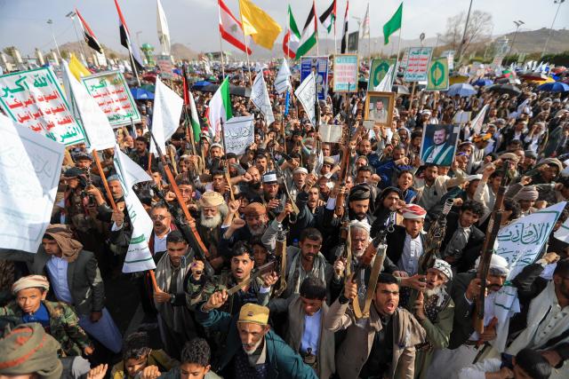 Armed Yemeni supporters of the Iran-backed Houthi movement brandish their weapons during a protest against US strikes on Iran in Sanaa on July 10, 2026. Iran's top negotiator Mohammad Bagher Ghalibaf on July 10 said the conflict with the United States would not end with Tehran's surrender, after hostilities between the decades-old foes resumed this week with tit-for-tat attacks. (Photo by Mohammed HUWAIS / AFP)