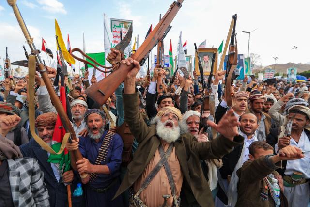 Armed Yemeni supporters of the Iran-backed Houthi movement brandish their weapons during a protest against US strikes on Iran in Sanaa on July 10, 2026. Iran's top negotiator Mohammad Bagher Ghalibaf on July 10 said the conflict with the United States would not end with Tehran's surrender, after hostilities between the decades-old foes resumed this week with tit-for-tat attacks. (Photo by Mohammed HUWAIS / AFP)
