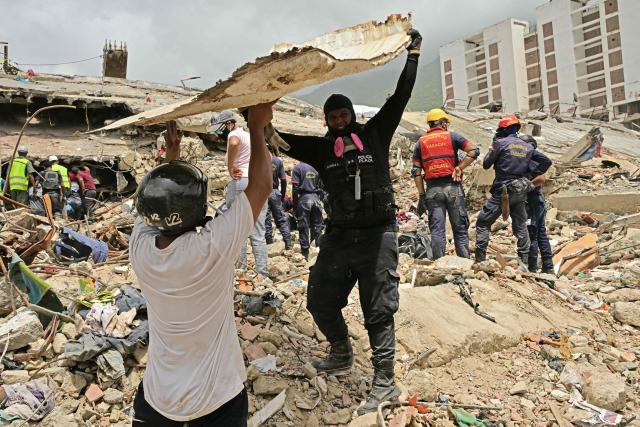 Rescuers search for victims at the site of collapsed buildings in Caraballeda, state of La Guaira, Venezuela, on July 10, 2026, following the June 24 twin earthquakes. The death toll from the powerful double earthquake has risen to at least 3,889, whilst the number of injured remains at almost 17,000, and nearly 18,000 people were left homeless according to the last official reports. (Photo by MARTIN BERNETTI / AFP)
