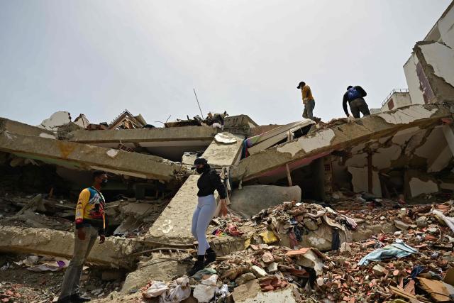 Relatives of missing people look for their corpses at the site of collapsed buildings in Caraballeda, state of La Guaira, Venezuela, on July 10, 2026, following the June 24 twin earthquakes. The death toll from the powerful double earthquake has risen to at least 3,889, whilst the number of injured remains at almost 17,000, and nearly 18,000 people were left homeless according to the last official reports. (Photo by MARTIN BERNETTI / AFP)