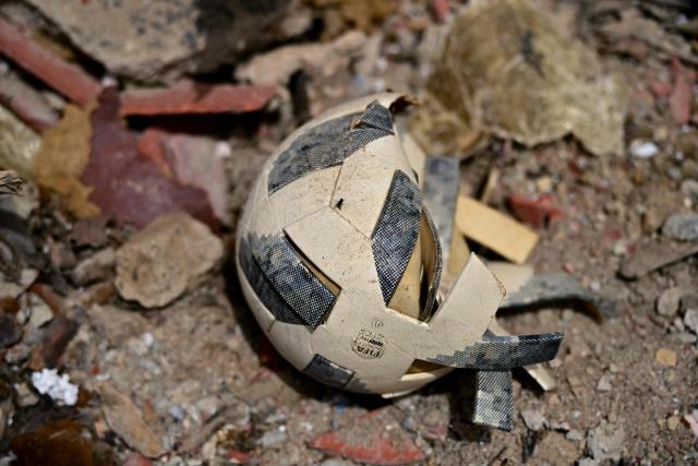 This image shows a football amid rubble in the site of a collapsed building in Caraballeda, state of La Guaira, Venezuela, on July 10, 2026, following the June 24 twin earthquakes. The death toll from the powerful double earthquake has risen to at least 3,889, whilst the number of injured remains at almost 17,000, and nearly 18,000 people were left homeless according to the last official reports. (Photo by MARTIN BERNETTI / AFP)