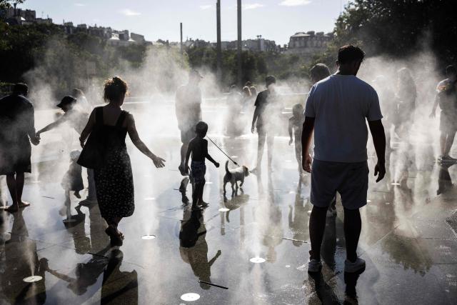 Children play in a splash pad during a heatwave in Paris on July 10, 2026. (Photo by Behrouz MEHRI / AFP)