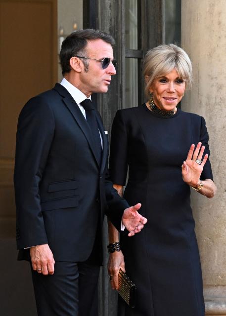 France's President Emmanuel Macron and to his wife Brigitte Macron pose at The Elysee Presidential Palace ahead of an official state dinner with South Africa's President and representatives in Paris on July 10, 2026. (Photo by JULIEN DE ROSA / AFP)