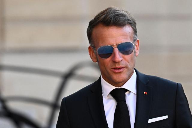 France's President Emmanuel Macron wearing sunglasses looks on as he arrives to greet his South African counterpart at the Elysee Presidential Palace ahead of an official state dinner in Paris on July 10, 2026. (Photo by JULIEN DE ROSA / AFP)