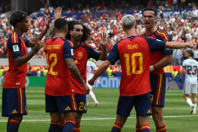 Spain's midfielder #08 Fabian Ruiz (R) celebrates scoring his team's first goal with teammates during the 2026 World Cup football tournament quarter-final match between Spain and Belgium at the Los Angeles Stadium in Inglewood on July 10, 2026.  (Photo by Patrick T. Fallon / AFP)