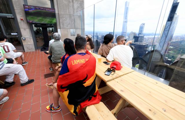 Fans watch the World Cup quarterfinal football match between Spain and Belgium on a screen from the observation deck at Rockefeller Center in New York on July 10, 2026. (Photo by TIMOTHY A. CLARY / AFP)