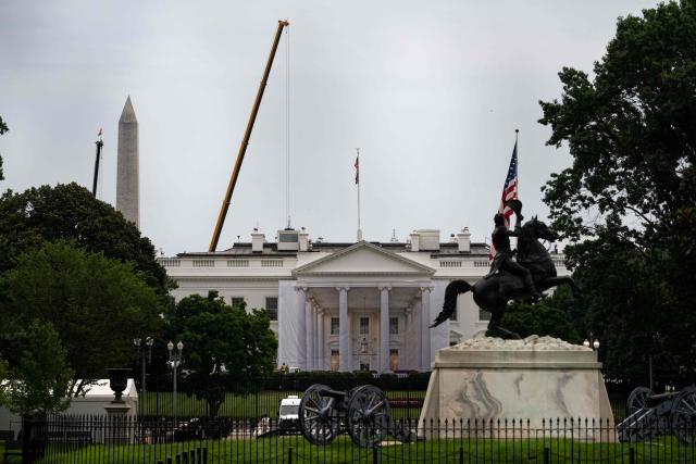A protective cover featuring a rendering of the White House’s North Portico is visible around the portico’s columns, where scaffolding has been erected at the north side entrance of the White House in Washington, DC, on July 10, 2026. (Photo by Kent Nishimura / AFP)