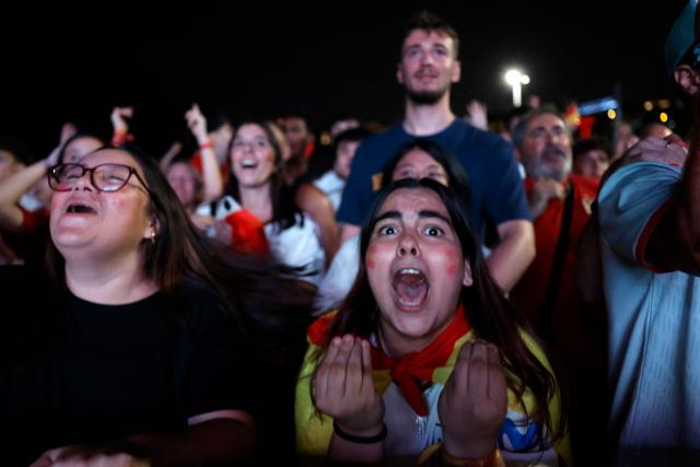 Spain supporters celebrate Spain's second goal while watching the 2026 FIFA World Cup quarterfinal match between Spain and Belgium on a giant screen in Madrid on July 10, 2026. (Photo by Oscar DEL POZO / AFP)