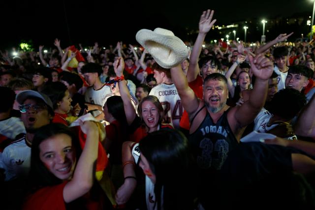 Spain supporters celebrate Spain's second goal while watching the 2026 FIFA World Cup quarterfinal match between Spain and Belgium on a giant screen in Madrid on July 10, 2026. (Photo by Oscar DEL POZO / AFP)