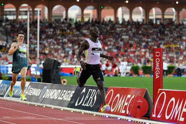 Kenya's Emmanuel Wanyonyi (R) crosses the finish line to win the men's 1000m during the Diamond League athletics meeting at the Stade Louis II in Monaco on July 10, 2026. (Photo by Frederic Dides / AFP)