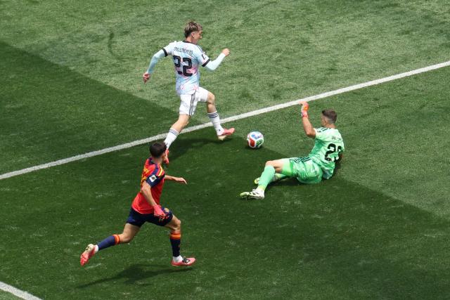 Belgium's forward #22 Alexis Saelemaekers runs with the ball past Spain's goalkeeper #23 Unai Simon during the 2026 World Cup football tournament quarter-final match between Spain and Belgium at the Los Angeles Stadium in Inglewood on July 10, 2026.  (Photo by VALERIE MACON / AFP)