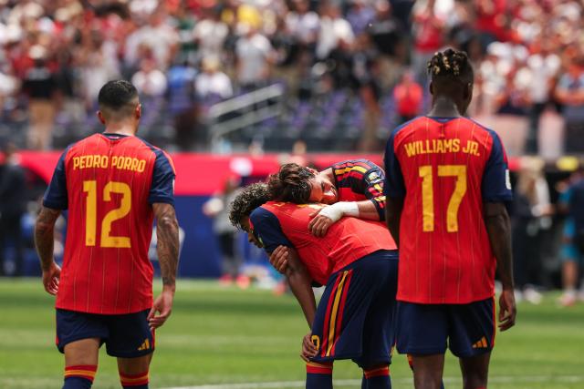 Spain's forward #07 Ferran Torres (R) hugs forward #19 Lamine Yamal after winning the 2026 World Cup football tournament quarter-final match between Spain and Belgium at the Los Angeles Stadium in Inglewood on July 10, 2026.  (Photo by ETIENNE LAURENT / AFP)