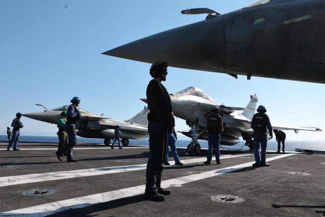 Marine Rafale airplane staff prepare to take off from the deck of the Charles de Gaulle Aircraft carrier coming back from its Lafayette 26 mission near Bonifacio of the French island of Corsica, southern France, on July 10, 2026. (Photo by Pascal POCHARD-CASABIANCA / AFP)