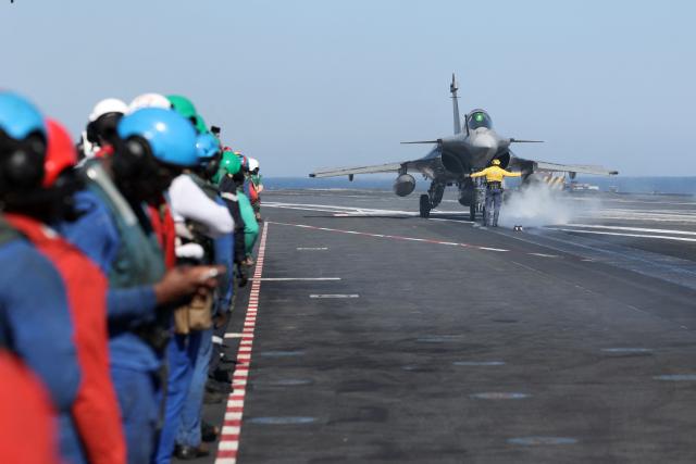 A Marine Rafale airplane gets ready to take off from the deck of the Charles de Gaulle Aircraft carrier coming back from its Lafayette 26 mission near Bonifacio of the French island of Corsica, southern France, on July 10, 2026. (Photo by Pascal POCHARD-CASABIANCA / AFP)