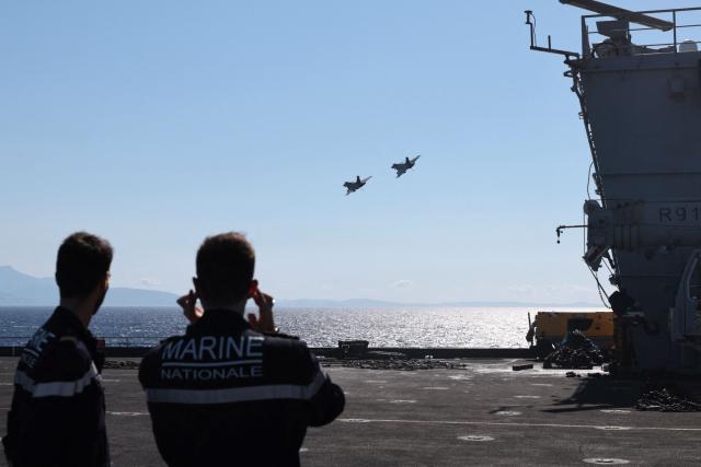 Two Marine Rafale airplanes fly over the Mediterranean Sea after taking off from the Charles de Gaulle Aircraft carrier coming back from its Lafayette 26 mission near Bonifacio of the French island of Corsica, southern France, on July 10, 2026. (Photo by Pascal POCHARD-CASABIANCA / AFP)
