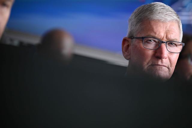Apple CEO Tim Cook listens to US President Joe Biden deliver remarks on his economic plan at TSMC Semiconductor Manufacturing Facility in Phoenix, Arizona, on December 6, 2022. Apple on July 10 sued OpenAI, accusing the artificial intelligence company of orchestrating a campaign to steal the iPhone maker's trade secrets as it tries to develop its own consumer hardware device. The lawsuit -- filed in a federal court in San Jose, California -- paints a picture of an aggressive effort by OpenAI to poach Apple employees and extract confidential information to build its own device (Photo by Brendan SMIALOWSKI / AFP)