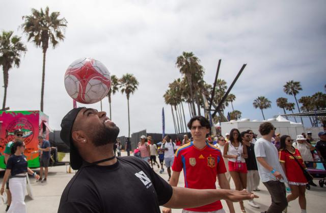 Fans play football after attending a watch party for the World Cup quarterfinal match between Spain and Belgium at the Venice Beach FIFA Fan Festival in Venice, California, on July 10, 2026. (Photo by Apu GOMES / AFP)