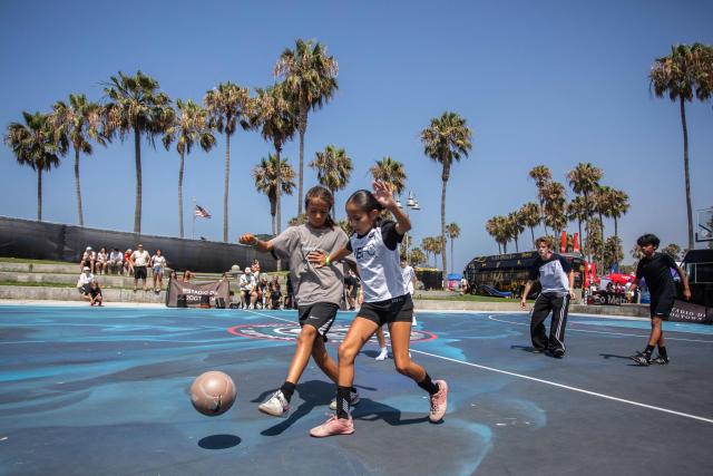 Kids play football before the start of a watch party for the World Cup quarterfinal match between Spain and Belgium at the Venice Beach FIFA Fan Festival in Venice, California, on July 10, 2026. (Photo by Apu GOMES / AFP)