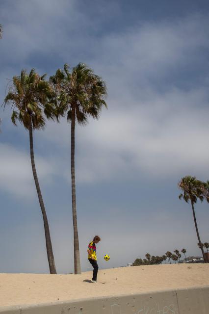 A young man plays football the start of a watch party for the World Cup quarterfinal match between Spain and Belgium at the Venice Beach FIFA Fan Festival in Venice, California, on July 10, 2026. (Photo by Apu GOMES / AFP)