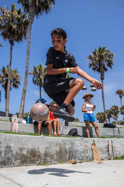 A girl plays football before the start of a watch party for the World Cup quarterfinal match between Spain and Belgium at the Venice Beach FIFA Fan Festival in Venice, California, on July 10, 2026. (Photo by Apu GOMES / AFP)