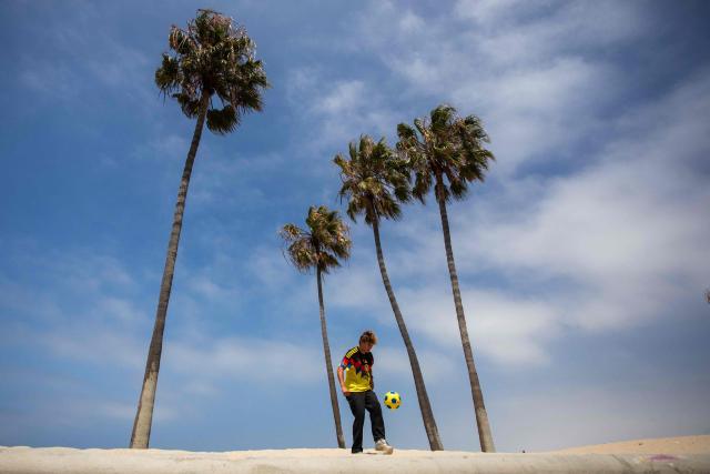 A young man plays football the start of a watch party for the World Cup quarterfinal match between Spain and Belgium at the Venice Beach FIFA Fan Festival in Venice, California, on July 10, 2026. (Photo by Apu GOMES / AFP)