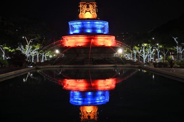The base of the Altamira obelisk is illuminated in the colors of the Venezuelan flag at Altamira Square in the Chacao municipality of Caracas on July 10, 2026. (Photo by Raul ARBOLEDA / AFP)