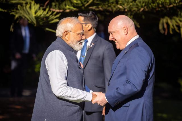 India's Prime Minister Narendra Modi (L) is welcomed by New Zealand's Prime Minister Christopher Luxon (R) at Government House in Wellington on July 11, 2026. (Photo by BRUCE MACKAY / POOL / AFP)