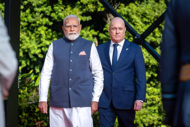 India's Prime Minister Narendra Modi (L) is welcomed by New Zealand's Prime Minister Christopher Luxon (R) at Government House in Wellington on July 11, 2026. (Photo by BRUCE MACKAY / POOL / AFP)