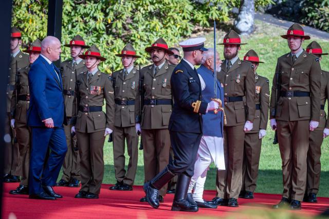 India's Prime Minister Narendra Modi (R) inspect a Guard of Honour with New Zealand's Prime Minister Christopher Luxon (L) at Government House in Wellington on July 11, 2026. (Photo by BRUCE MACKAY / POOL / AFP)