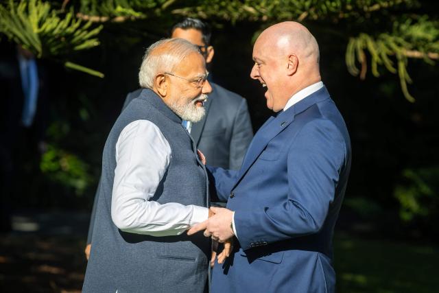 India's Prime Minister Narendra Modi (L) is welcomed by New Zealand's Prime Minister Christopher Luxon (R) at Government House in Wellington on July 11, 2026. (Photo by BRUCE MACKAY / POOL / AFP)