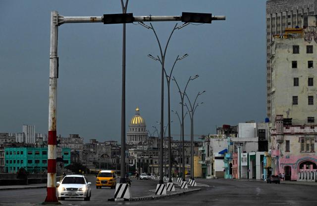 An unlit traffic light is seen during a nationwide blackout in Havana on July 10, 2026. Cuba suffered its second nationwide blackout in five days on July 10 as twin energy and economic crises, compounded by a six-month US fuel blockade, caused the electricity grid to collapse. (Photo by YAMIL LAGE / AFP)